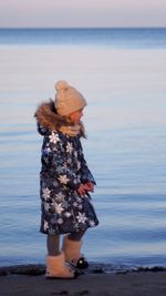 Rear view of woman standing on beach