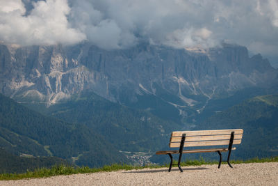 Empty bench on mountain range