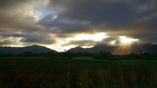 Scenic view of landscape against cloudy sky