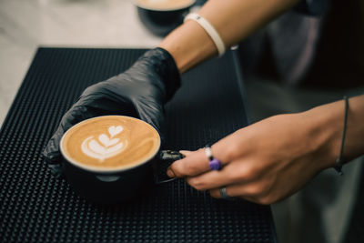 Midsection of man holding coffee