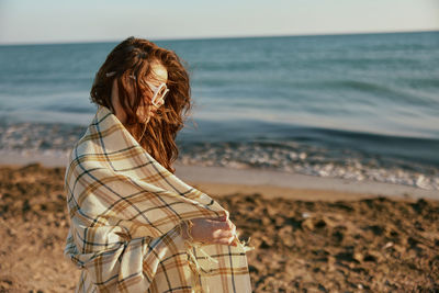 Young woman standing at beach