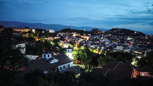High angle view of illuminated buildings in city at night