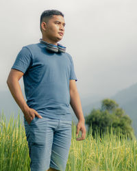 Young man looking away on field