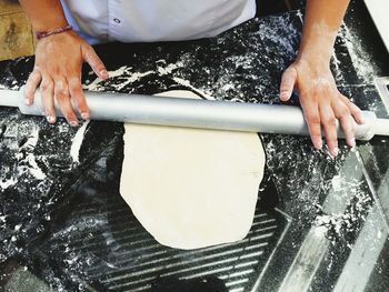 Hands using rolling pin