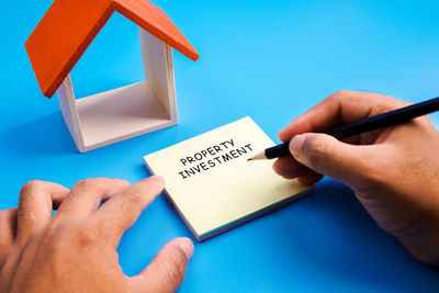 Midsection of person holding paper with text