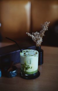 Close-up of green tea latte on table