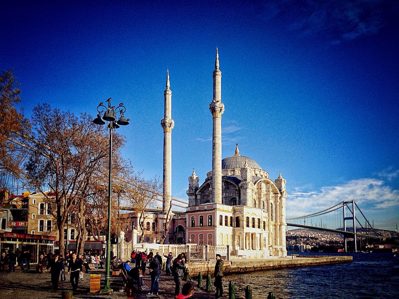 architecture, built structure, blue, building exterior, men, person, lifestyles, large group of people, sky, leisure activity, clear sky, famous place, city, travel destinations, tourism, tower, travel, walking, copy space