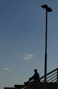 Low angle view of silhouette bird perching against sky