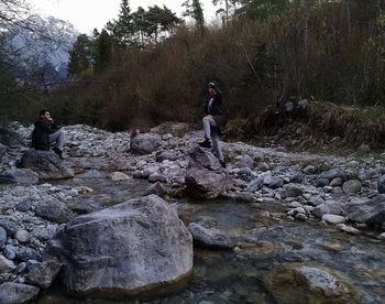 Rear view of people enjoying in water