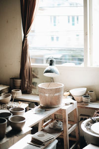 Bowls and lamp on table in workshop