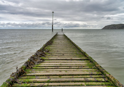 Pier over sea against sky