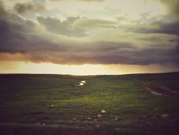 Scenic view of landscape against cloudy sky