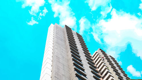 Low angle view of modern building against blue sky