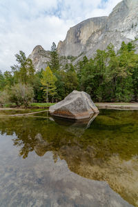 Scenic view of lake by mountain against sky