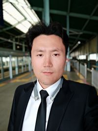 Portrait of well-dressed businessman at railroad station