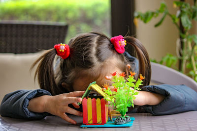 Portrait of girl sitting on table