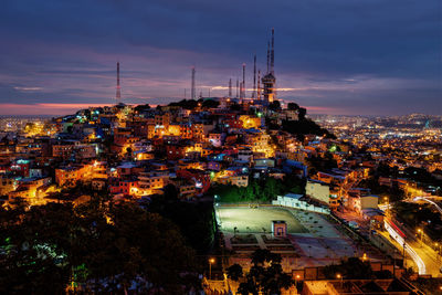 High angle view of illuminated buildings in city at night