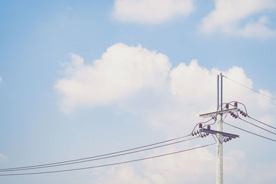 Low angle view of electricity pylon against sky