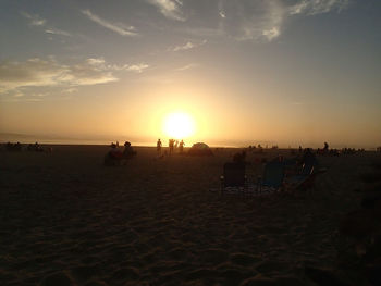 People on beach at sunset
