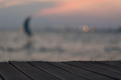 Pier over sea against sky during sunset