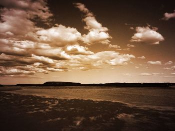 Scenic view of sea against cloudy sky