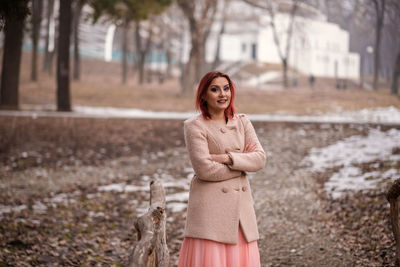 Portrait of young woman standing outdoors