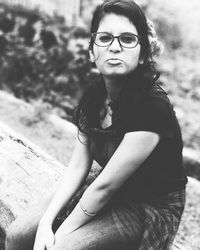 Portrait of young woman sitting outdoors