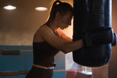 Young woman exercising in gym