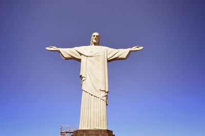 Low angle view of statue against blue sky