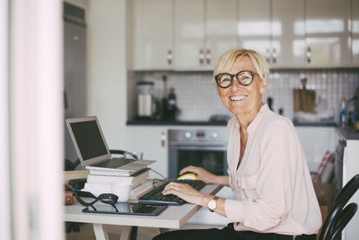 Portrait of happy woman working at home