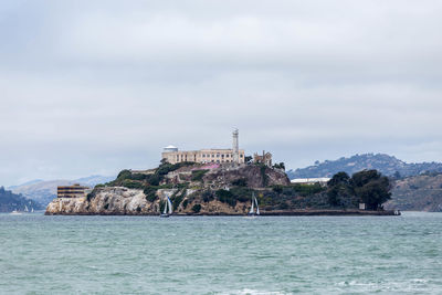 Scenic view of sea and buildings against sky