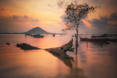 Scenic view of sea against orange sky