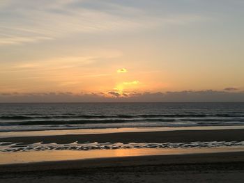 Scenic view of beach against sky during sunset