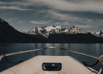 Scenic view of lake by mountains against sky