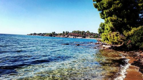 Scenic view of sea against clear blue sky