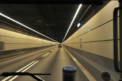 Illuminated tunnel at night