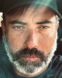 Close-up of bearded man looking away