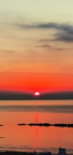 Scenic view of sea against romantic sky at sunset