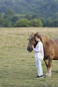 Teenage girl with horses on field