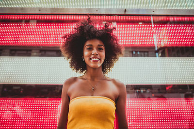 Portrait of smiling young woman standing outdoors