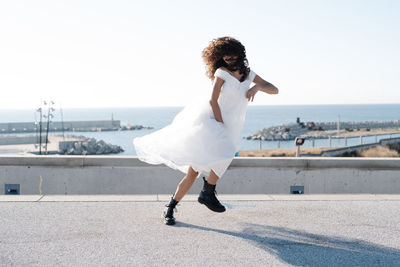 Full length of woman on sea against sky