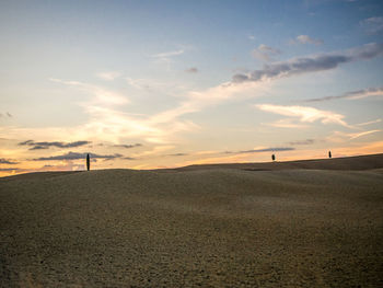 Scenic view of field against sky at sunset