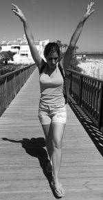 Full length of woman standing on footbridge