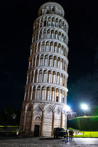 Low angle view of illuminated building against sky at night