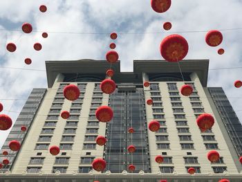 Low angle view of lanterns hanging against sky