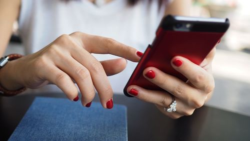 Midsection of woman using smart phone