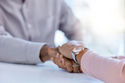 Midsection of woman holding hands