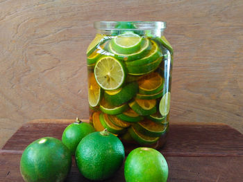 Green fruits in jar on table