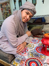 Happy young man sitting on table