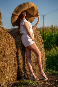 Full length of young woman standing on field